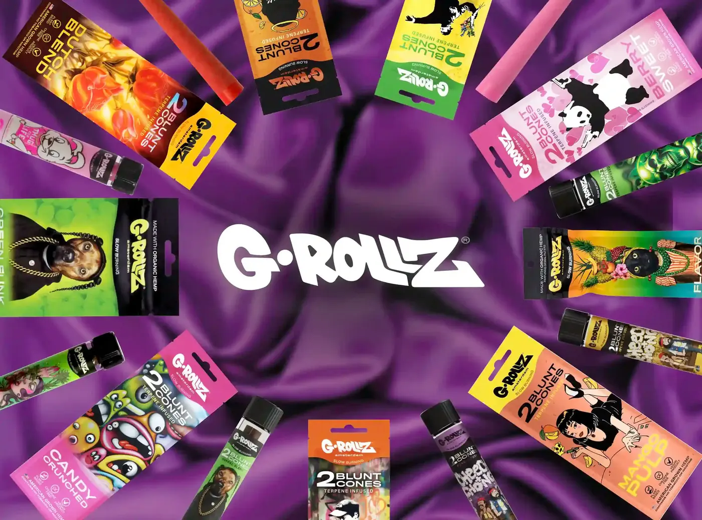 G-Rollz cone packs and glass tubes arranged on purple silk beneath the G-Rollz logo