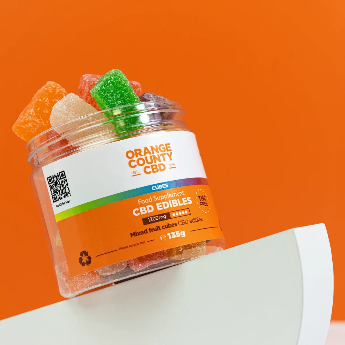 Orange County CBD 1200mg mixed fruit cubes edibles jar on the brand's orange campaign background